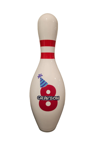 A custom bowling pin personalized for a birthday.