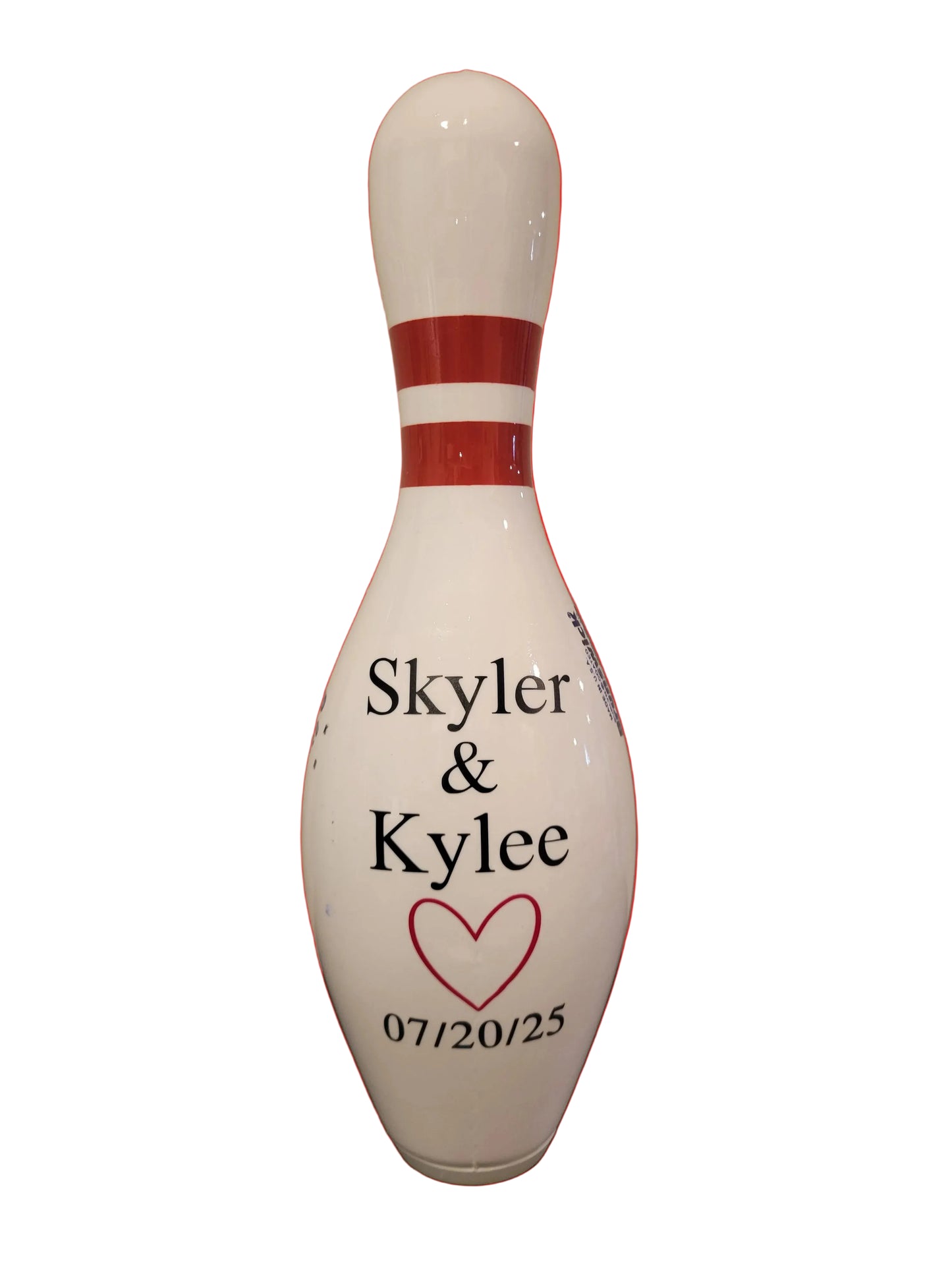 A bowling pin with personalized black text reading 'Skyler & Kylee', a red heart outline, and the date '07/20/25'.