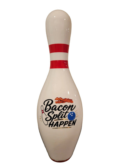 A custom bowling pin with the text 'Bacon Split HAPPEN' printed on the front, featuring bacon graphics and a blue bowling ball icon.
