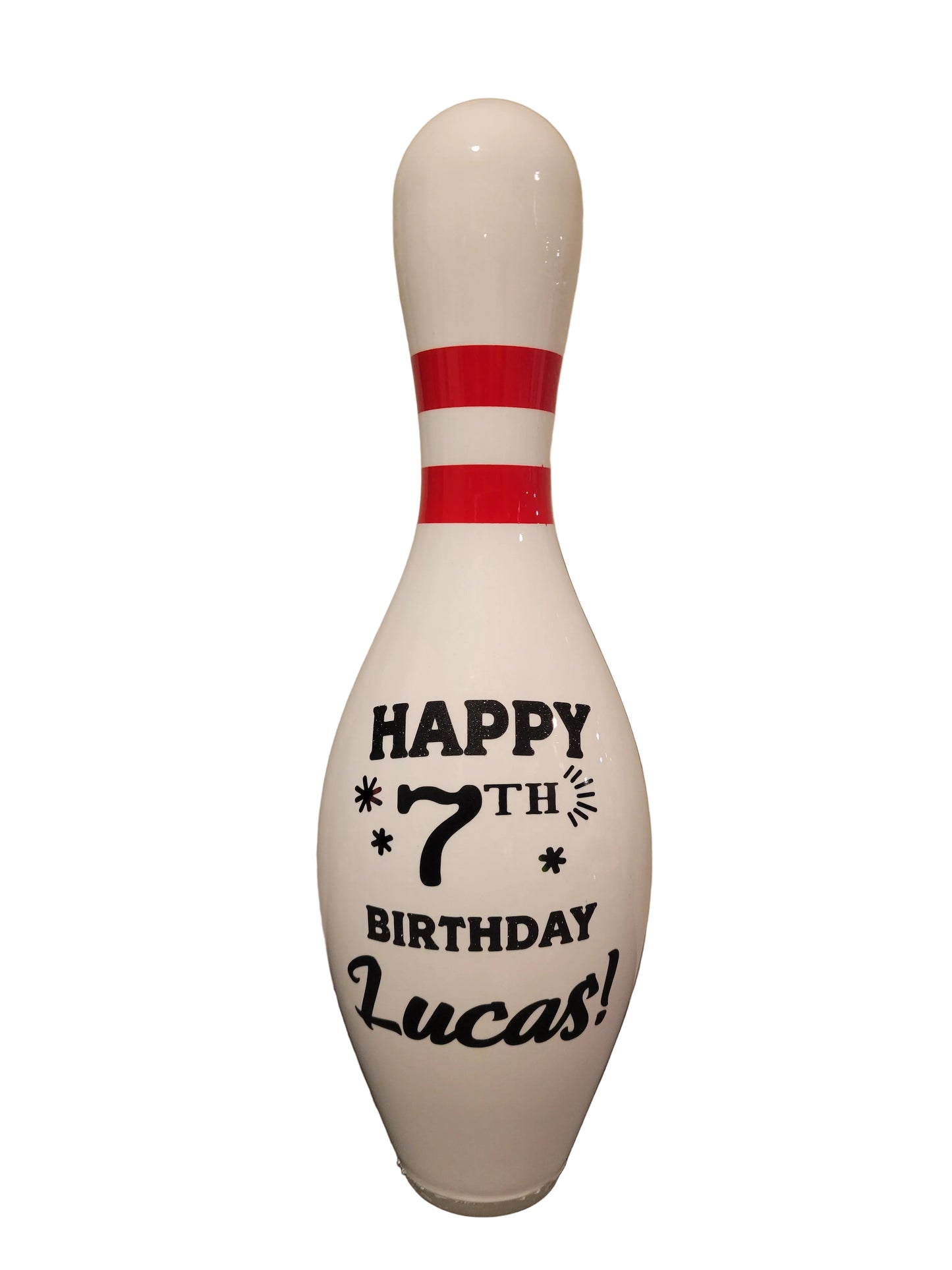 A custom bowling pin decorated with a birthday theme.