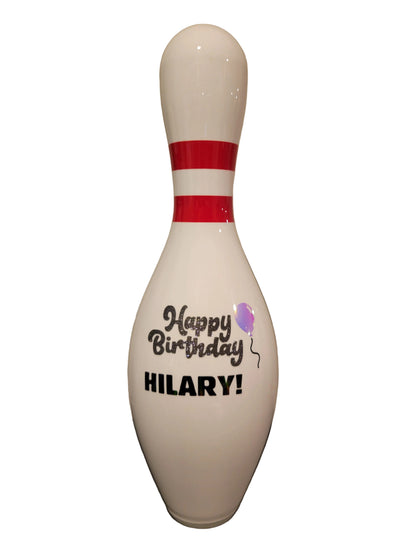 A custom white bowling pin with a 'Happy Birthday' design on the front.