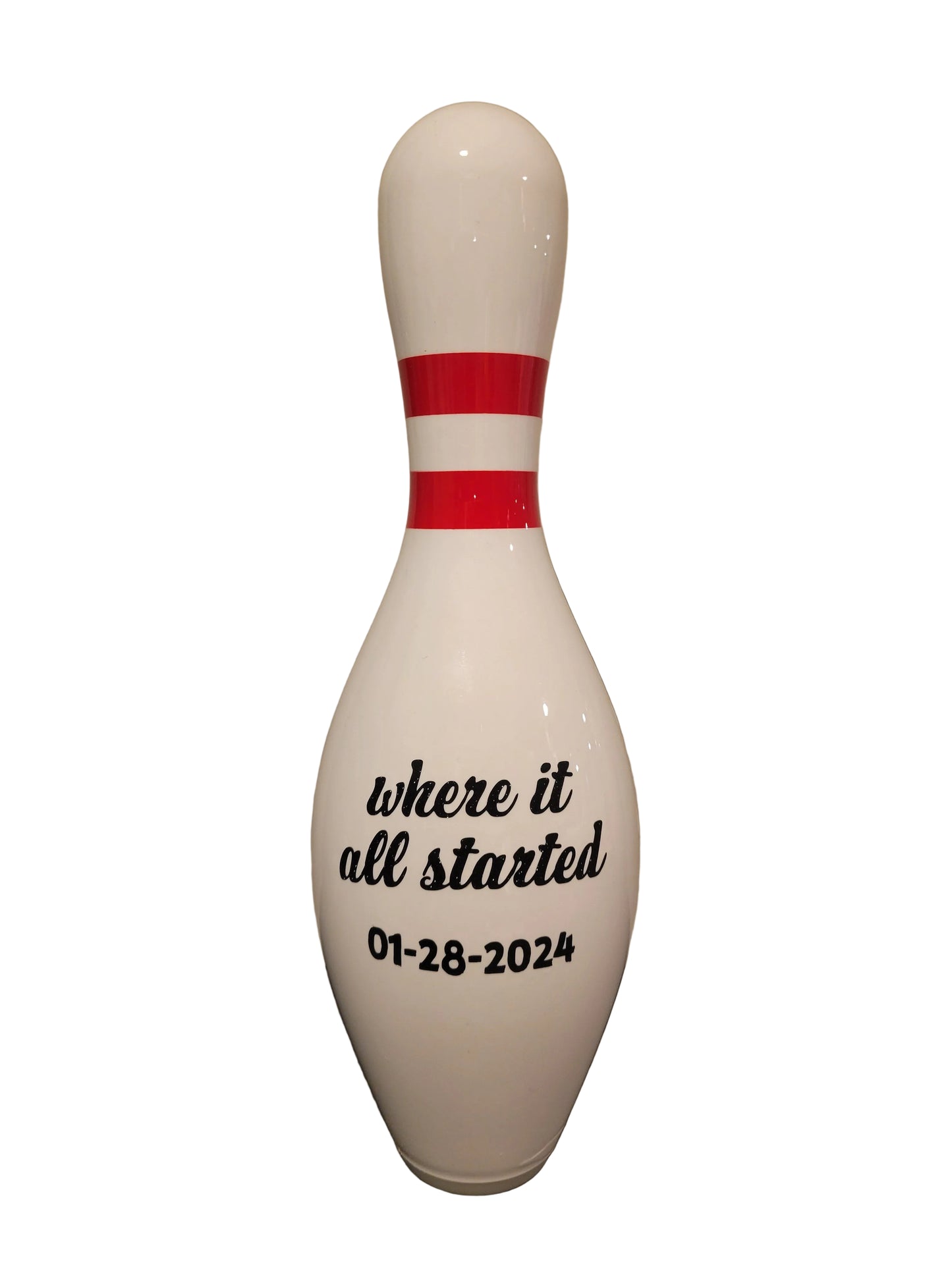 A white bowling pin with black printed text reading 'where it all started 01-28-2024'.
